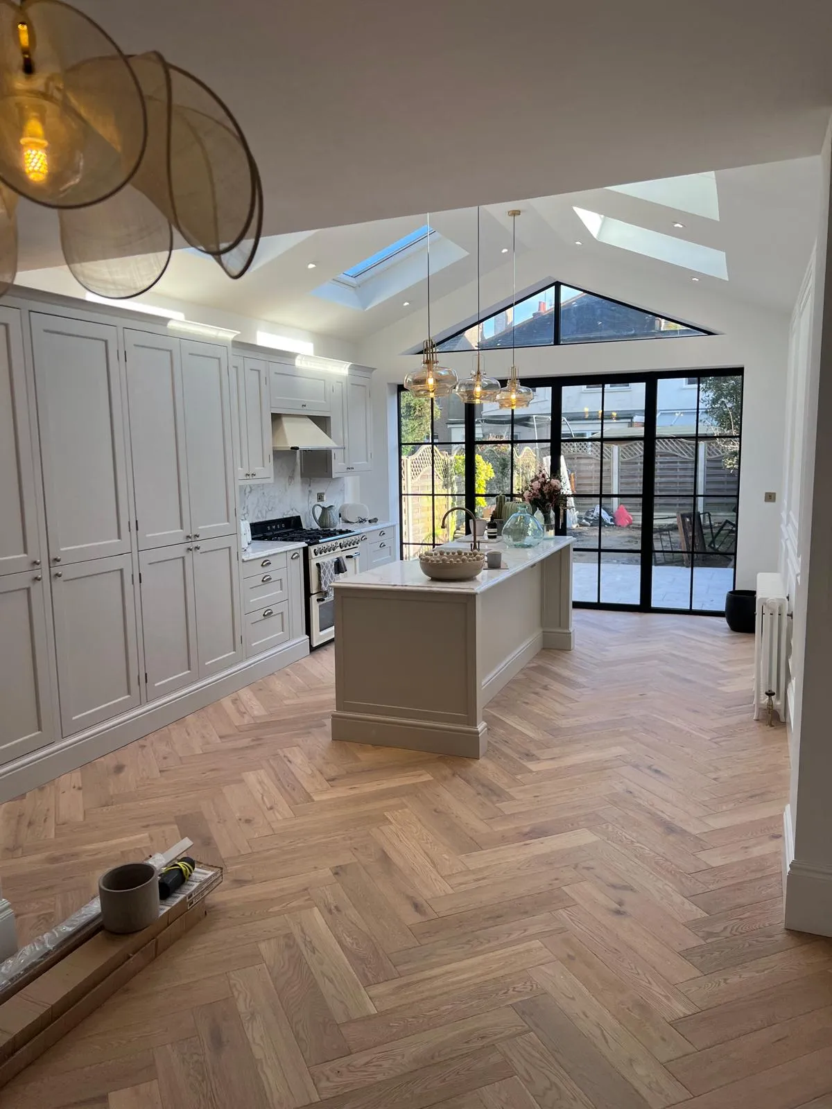A kitchen with a center island and a skylight.