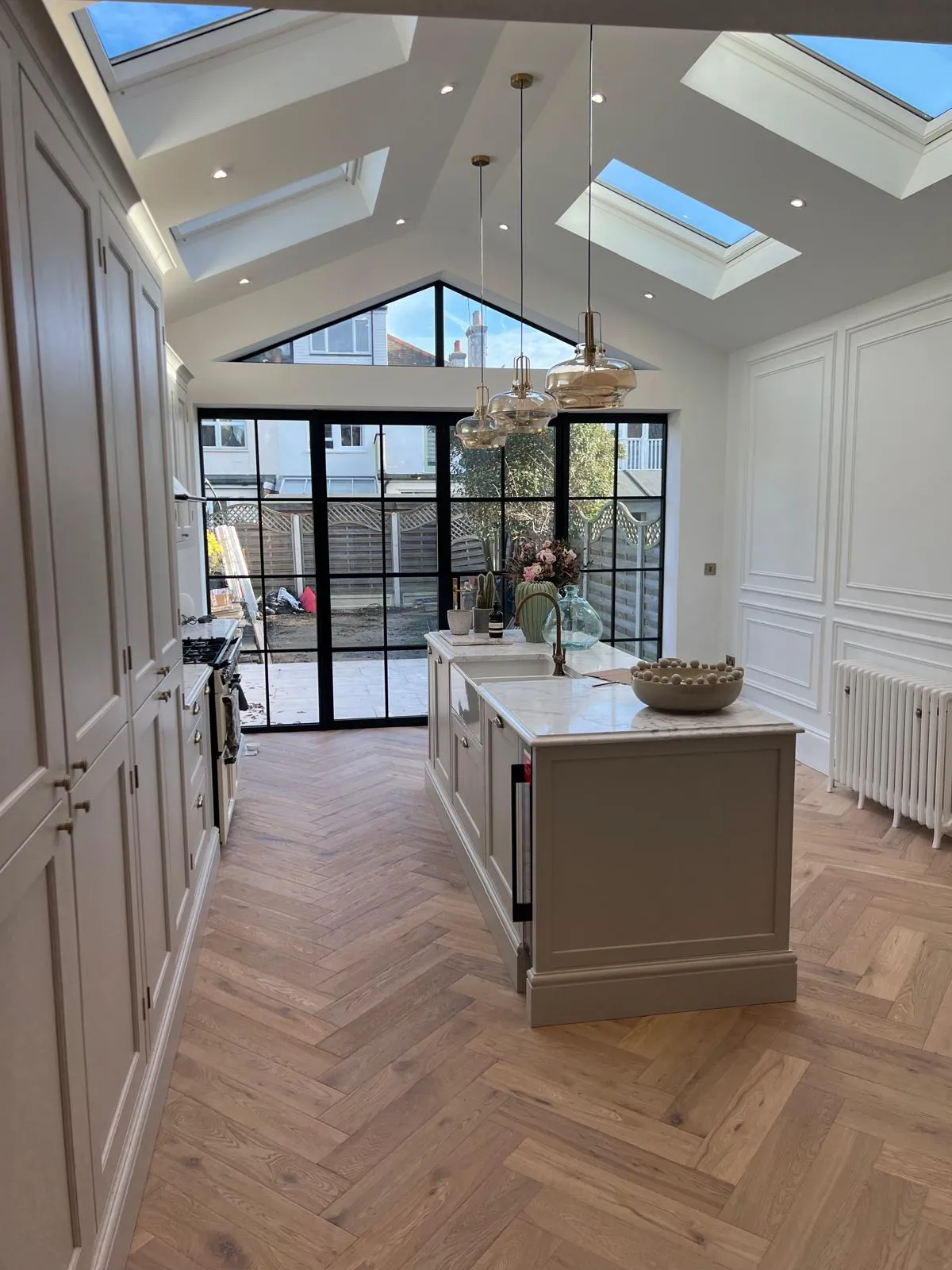 A kitchen with a center island and a skylight.