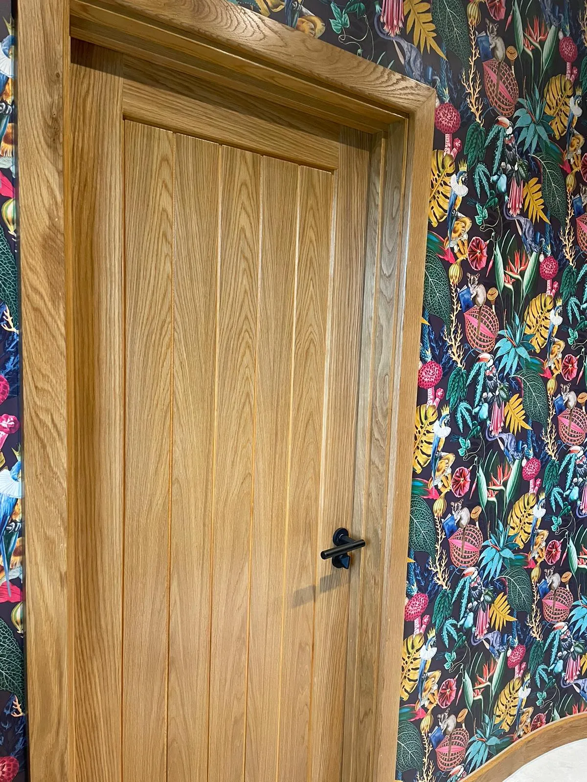wooden door with floral wallpaper