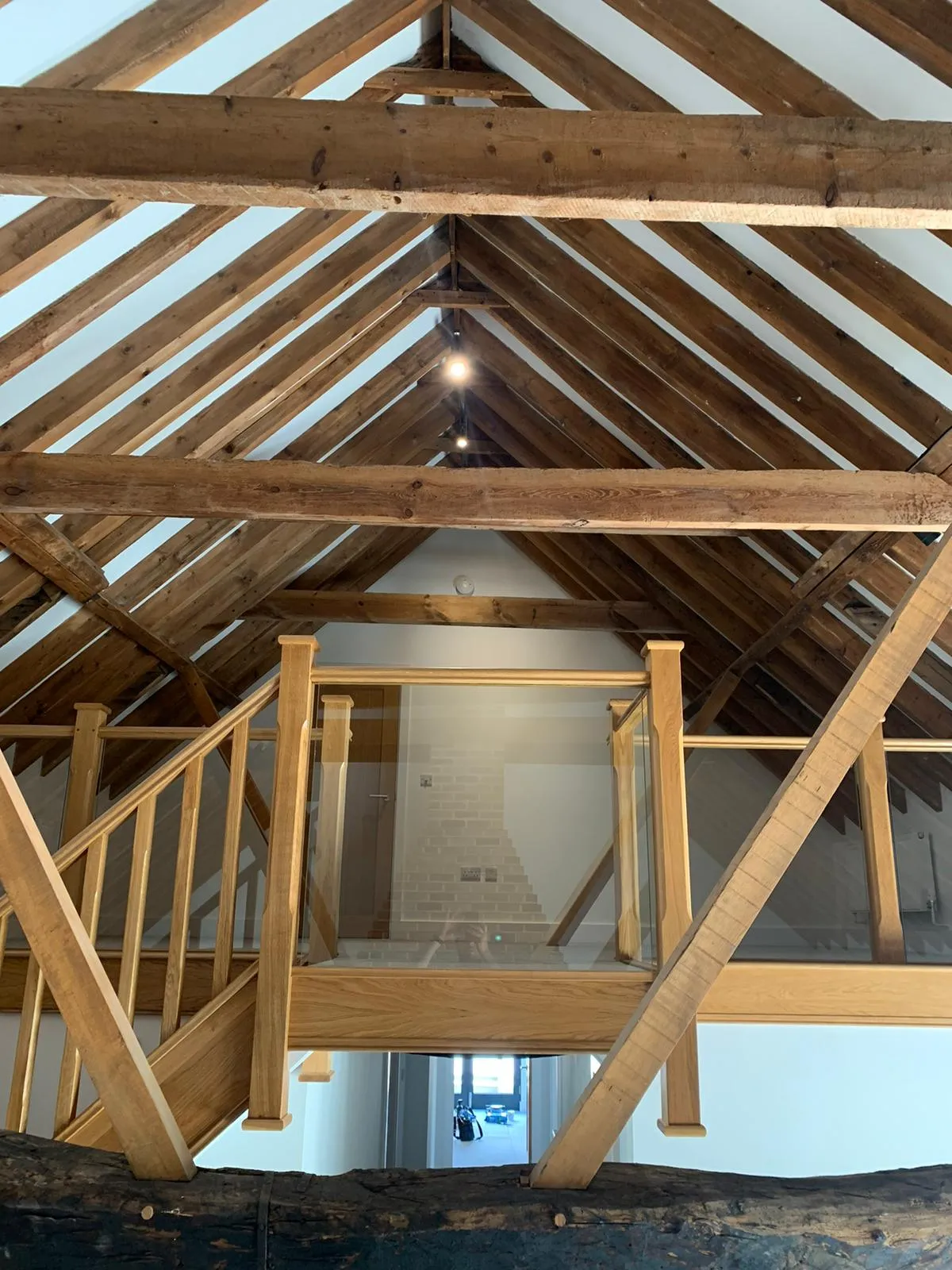 a room with a wooden ceiling and wooden stairs
