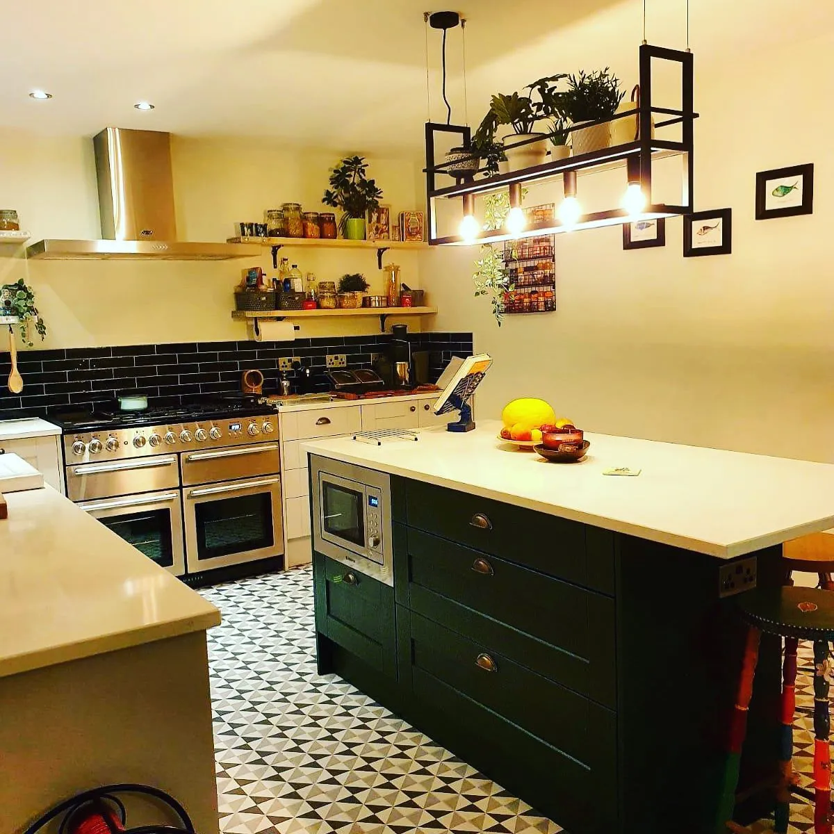 a kitchen with a sink, stove, oven and a counter