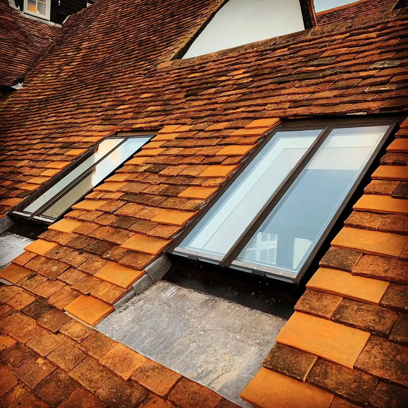 two windows on the roof of a building