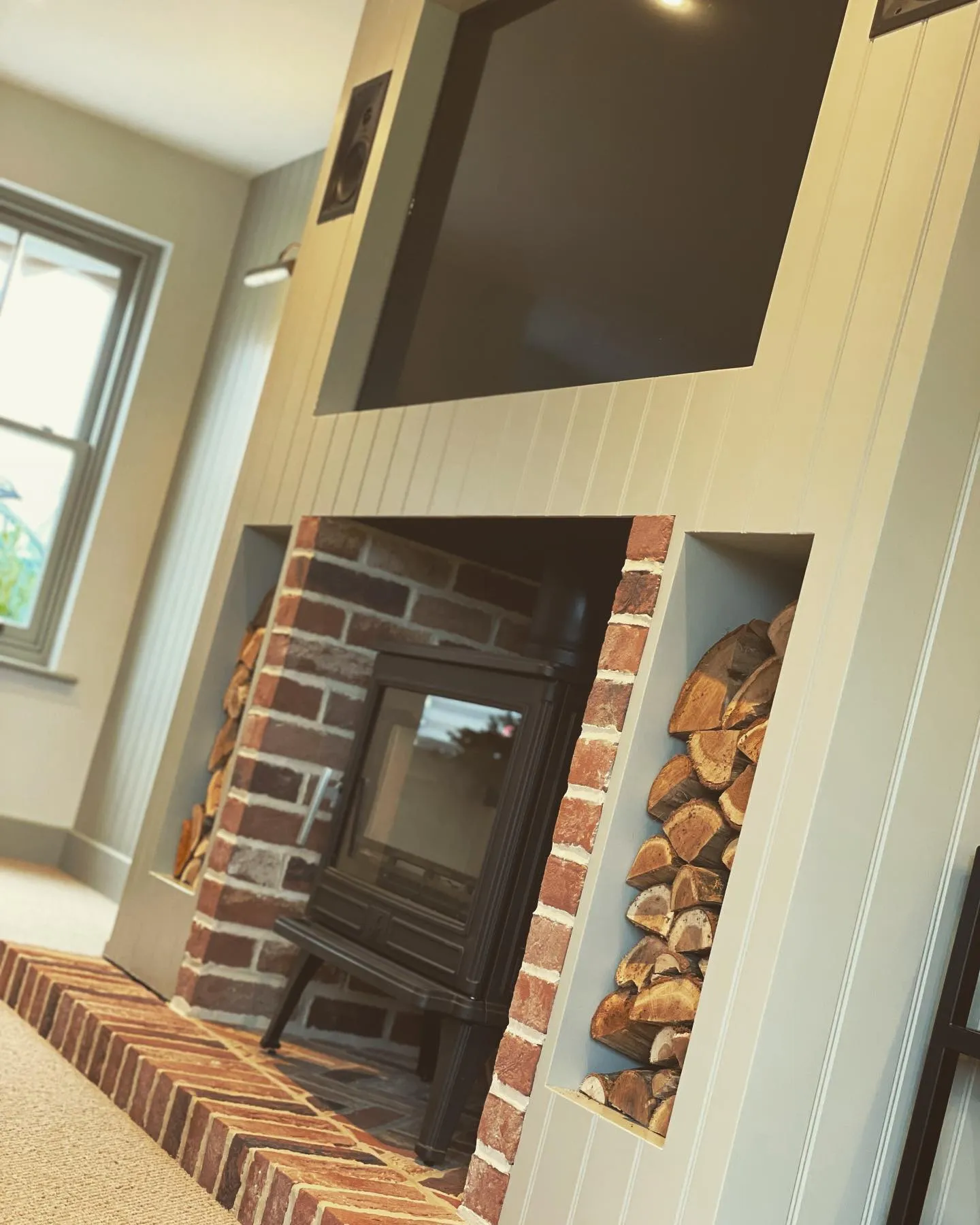 a fireplace with a television mounted on the wall