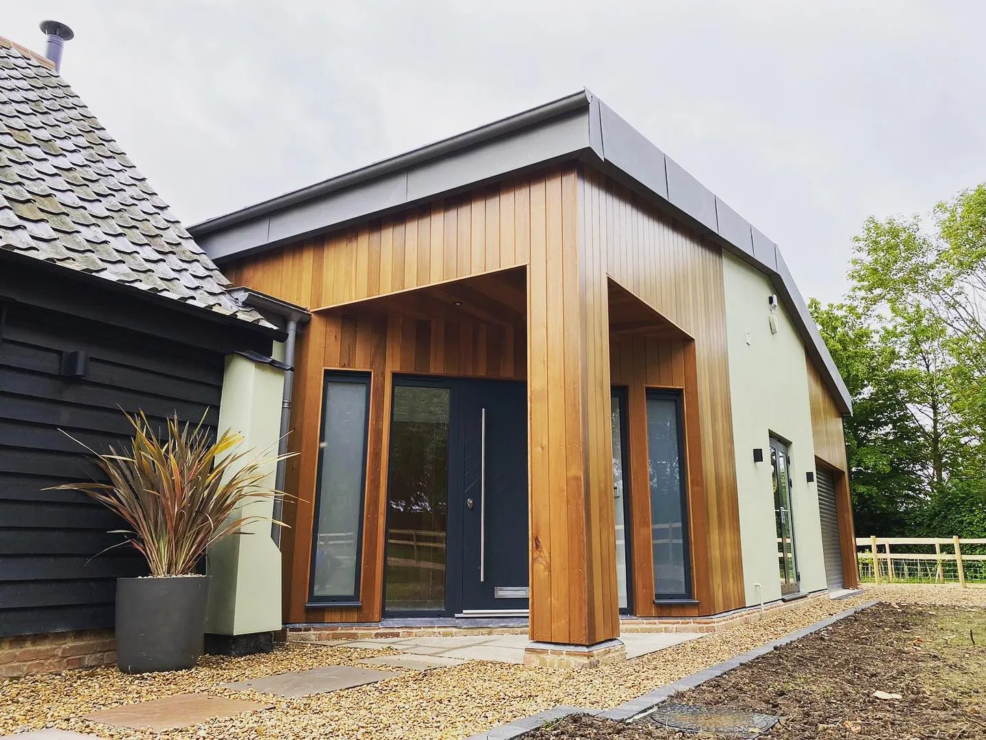 a house with a wooden roof and a black door