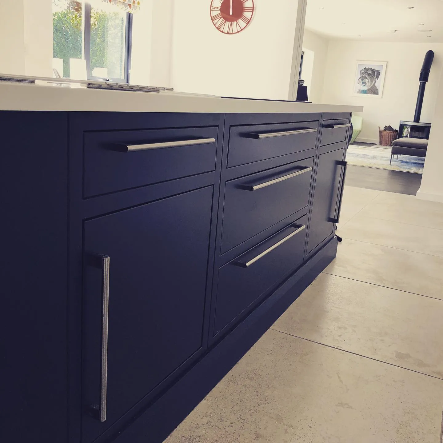 a kitchen with a counter top and a clock on the wall