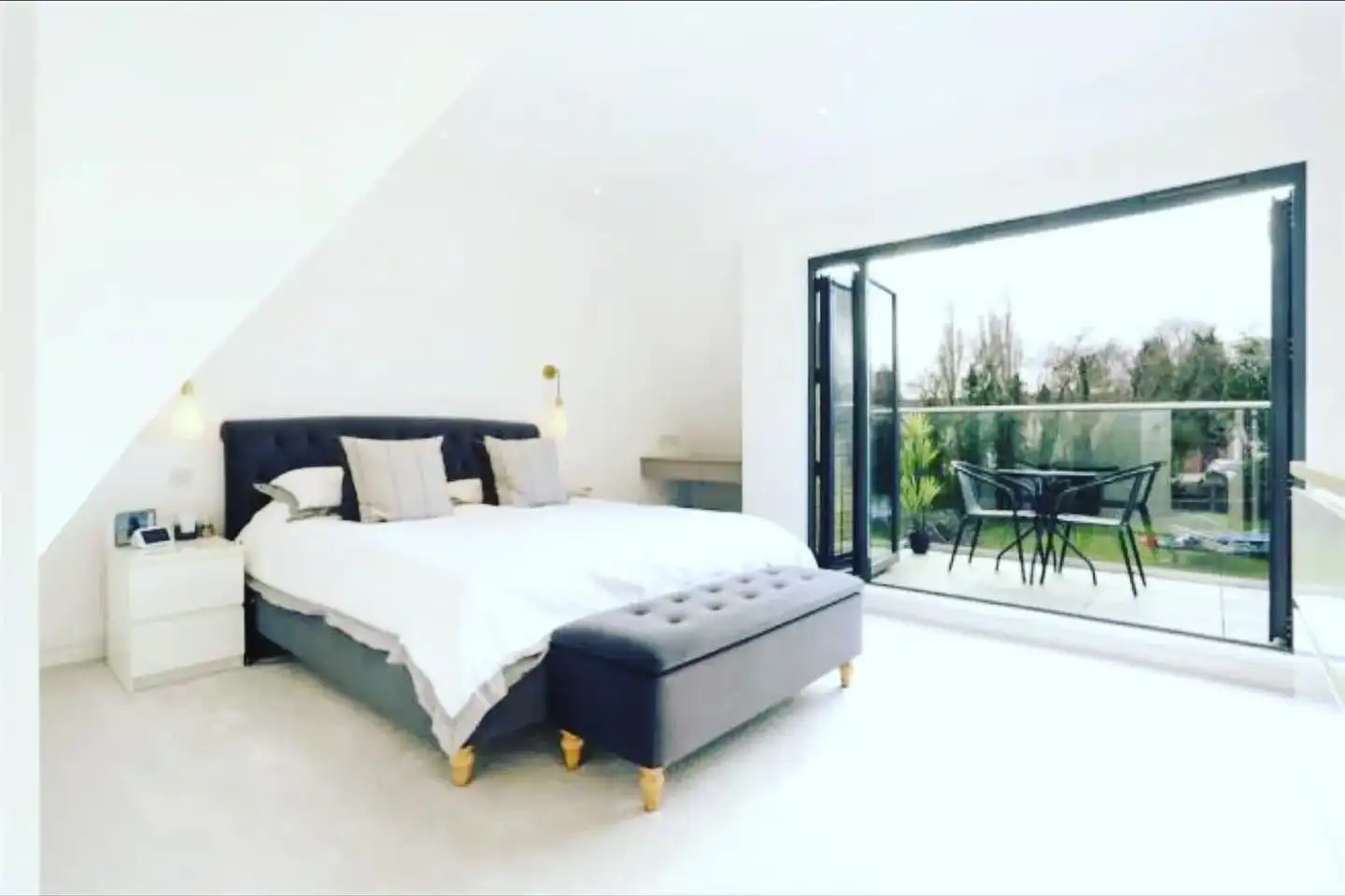 a bedroom with a large bed and a sliding glass door
