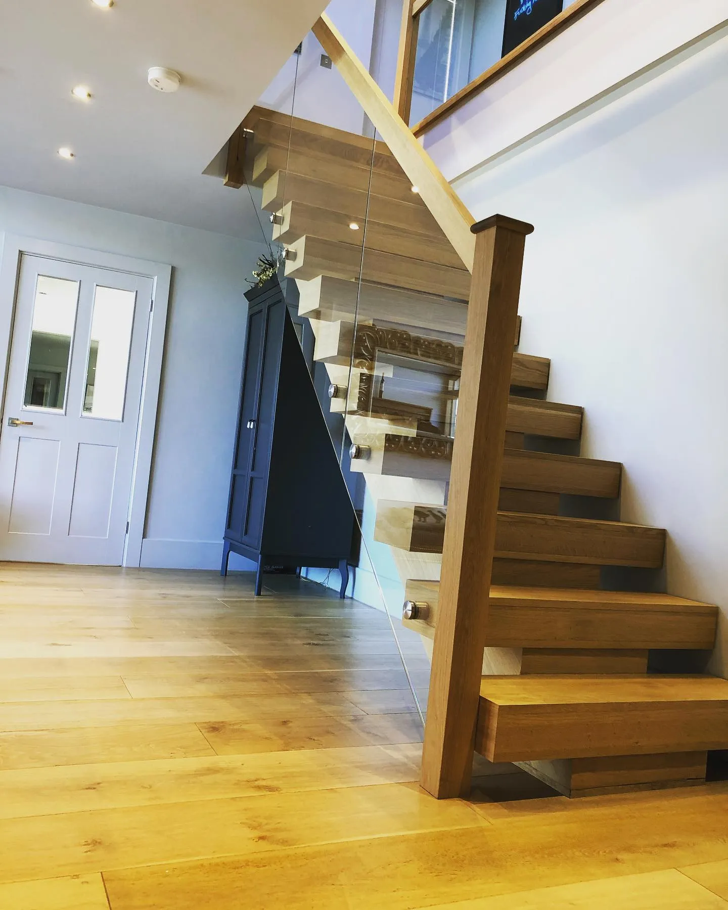 a wooden stair case in a home with hardwood floors