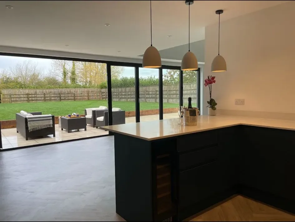 A large open kitchen with a sliding glass door.