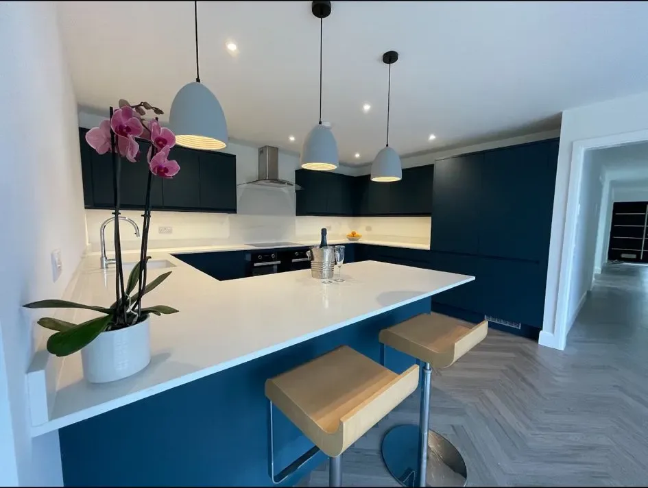A kitchen with a center island with stools.